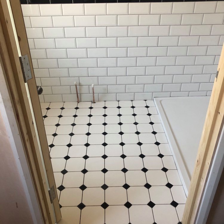 Waterlooville - En-suite lay wall and floor tiles .
