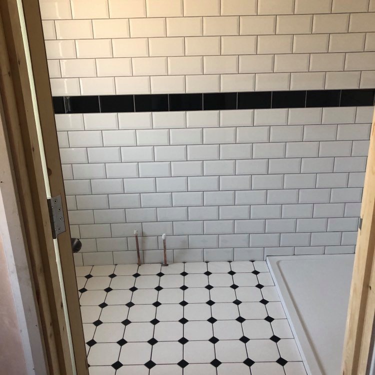 Waterlooville - En-suite lay wall and floor tiles .