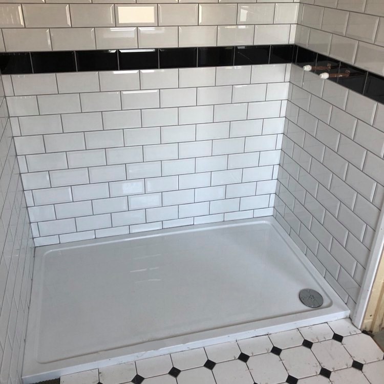 Waterlooville - En-suite lay wall and floor tiles .